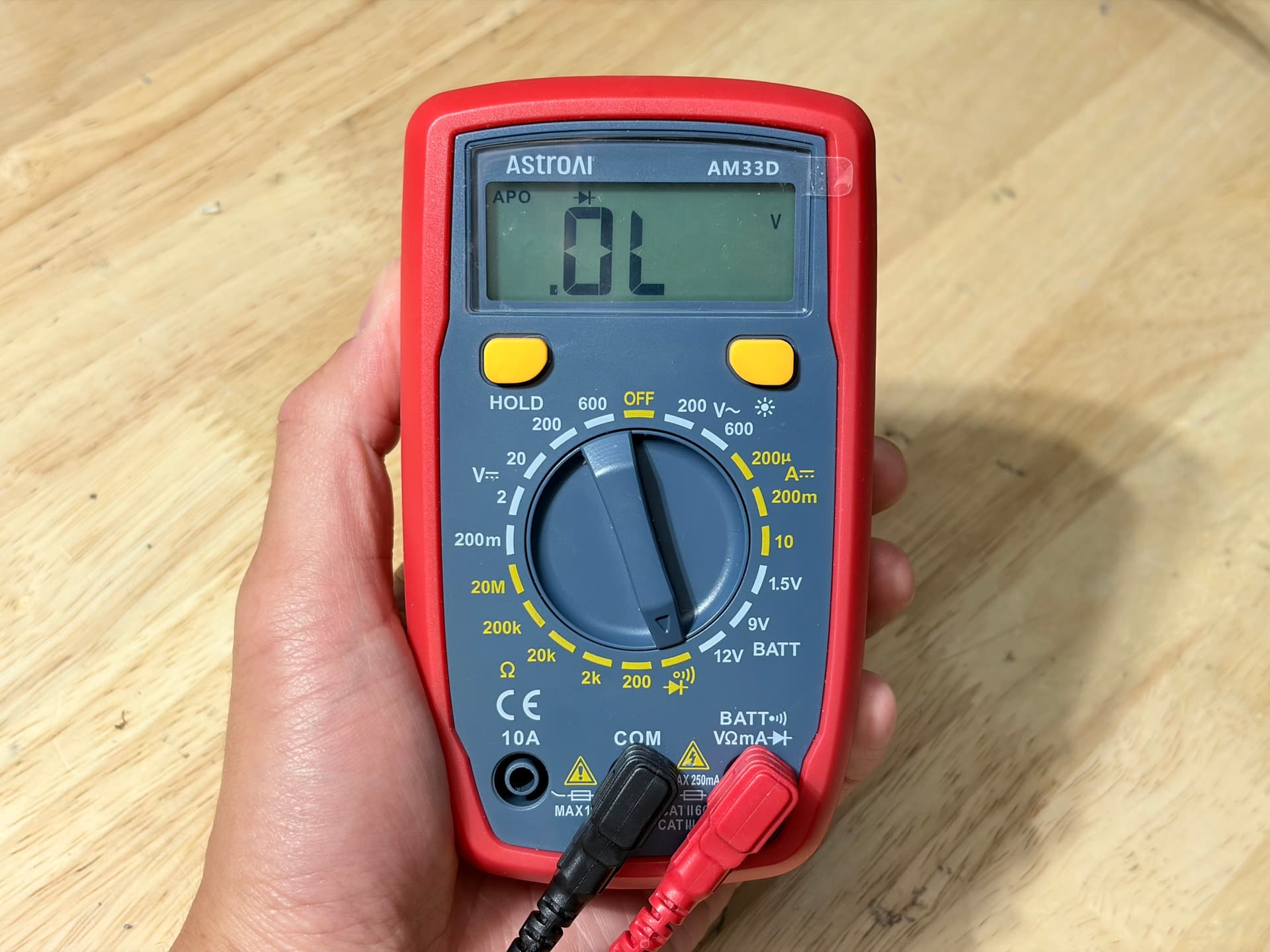 Multimeter with the dial set to the continuity / diode-test position. Display reads OL.